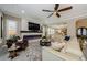 Inviting living room with stylish furniture, modern fireplace, and an open layout flowing into the dining area at 29038 Picana Ln, Wesley Chapel, FL 33543