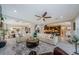 Spacious open-concept living room with elegant furnishings, opening to dining area, staircase, and modern kitchen at 29038 Picana Ln, Wesley Chapel, FL 33543