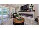 Stylish living room featuring a sleek fireplace, comfortable seating, and direct access to the outdoor pool area at 29038 Picana Ln, Wesley Chapel, FL 33543