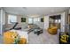 Spacious living room with high ceilings, multiple windows, and comfortable seating arrangement at 29038 Picana Ln, Wesley Chapel, FL 33543