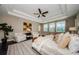 Serene main bedroom with tray ceiling, sitting area, and windows overlooking the pool at 29038 Picana Ln, Wesley Chapel, FL 33543