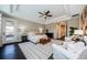 Elegant main bedroom with tray ceiling, a ceiling fan, and access to a private balcony at 29038 Picana Ln, Wesley Chapel, FL 33543