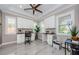 A spacious home office offers great lighting, modern white cabinets, a ceiling fan, and stylish decor at 29038 Picana Ln, Wesley Chapel, FL 33543