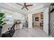 Bright office featuring white cabinets, modern desk, tray ceiling, and an open doorway to the rest of the house at 29038 Picana Ln, Wesley Chapel, FL 33543