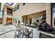 Outdoor kitchen and bar area with a built-in grill, seating, and tiled flooring for entertaining guests at 29038 Picana Ln, Wesley Chapel, FL 33543