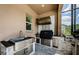 Covered outdoor kitchen is equipped with a stainless steel sink, grill, and countertop for easy meal prep at 29038 Picana Ln, Wesley Chapel, FL 33543