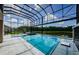 Screened-in pool area offers a gorgeous view of the lake and a tranquil spa at 29038 Picana Ln, Wesley Chapel, FL 33543