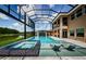 Stunning screened pool area with waterfall feature, a spa, and plenty of room for relaxing in the sun at 29038 Picana Ln, Wesley Chapel, FL 33543