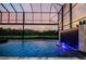 Relaxing screened pool with a captivating water feature and tranquil view of the surrounding landscape at 29038 Picana Ln, Wesley Chapel, FL 33543