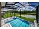 Stunning screened-in pool area boasts beautiful lake views and a relaxing spa at 29038 Picana Ln, Wesley Chapel, FL 33543