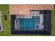 Aerial view of private screened pool with spa and lounge area; a luxurious backyard retreat at 29038 Picana Ln, Wesley Chapel, FL 33543