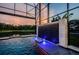Gorgeous screened pool includes a striking waterfall feature and calming lake view at 29038 Picana Ln, Wesley Chapel, FL 33543