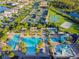 Stunning aerial view of the community amenities including multiple pools and tennis courts at 30326 Ceasar Park Dr, Wesley Chapel, FL 33543