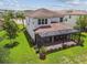 Aerial view showcasing the home's tile roof, screened lanai, and beautifully landscaped backyard at 30326 Ceasar Park Dr, Wesley Chapel, FL 33543