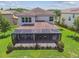 The backyard features a screened enclosure, lush landscaping, and a patio area, perfect for outdoor living at 30326 Ceasar Park Dr, Wesley Chapel, FL 33543