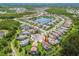Aerial view showcases the property's location within a community surrounding a picturesque lake at 30326 Ceasar Park Dr, Wesley Chapel, FL 33543