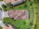Aerial view of the property featuring a tile roof, screened-in porch, and well-manicured landscaping at 30326 Ceasar Park Dr, Wesley Chapel, FL 33543