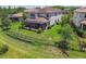 Aerial view of the home's lush backyard with a covered patio and beautiful landscaping at 30326 Ceasar Park Dr, Wesley Chapel, FL 33543