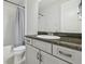 Bathroom with white vanity and silver hardware, tub, and shower with curtain at 30326 Ceasar Park Dr, Wesley Chapel, FL 33543