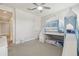 Bedroom featuring a bunk bed with a blue canopy, a ceiling fan, and neutral carpeting at 30326 Ceasar Park Dr, Wesley Chapel, FL 33543