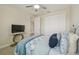 Bedroom with patterned comforter and view of closet at 30326 Ceasar Park Dr, Wesley Chapel, FL 33543