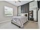 Modern bedroom with neutral tones, large mirrors, and a walk-in closet at 30326 Ceasar Park Dr, Wesley Chapel, FL 33543
