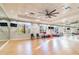 Bright community exercise room with wood floor, large mirror, and fitness equipment at 30326 Ceasar Park Dr, Wesley Chapel, FL 33543