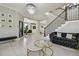 The home's grand foyer features tile flooring, chandelier, staircase, and modern decor at 30326 Ceasar Park Dr, Wesley Chapel, FL 33543