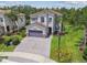 Charming two-story home with a paver driveway, lush landscaping, and a two-car garage at 30326 Ceasar Park Dr, Wesley Chapel, FL 33543