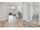 Upstairs hallway with wood floors leading to the primary bedroom at 30326 Ceasar Park Dr, Wesley Chapel, FL 33543