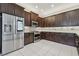 Modern kitchen with stainless steel appliances, dark cabinets, and subway tile backsplash at 30326 Ceasar Park Dr, Wesley Chapel, FL 33543