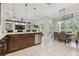 Open kitchen and dining area features an island with seating and stainless steel appliances at 30326 Ceasar Park Dr, Wesley Chapel, FL 33543