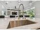 Gourmet kitchen with a sink and island that faces the living area at 30326 Ceasar Park Dr, Wesley Chapel, FL 33543