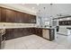 Spacious kitchen with dark wood cabinetry, stainless steel appliances, and a large island at 30326 Ceasar Park Dr, Wesley Chapel, FL 33543