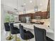 Modern kitchen boasts an island with seating, pendant lighting, and stainless steel appliances at 30326 Ceasar Park Dr, Wesley Chapel, FL 33543