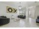 Stylish living room with tile flooring, accent furniture and a decorative chandelier at 30326 Ceasar Park Dr, Wesley Chapel, FL 33543