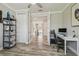 Office with desk, rolling chair, and shelving unit, conveniently located near the hallway at 30326 Ceasar Park Dr, Wesley Chapel, FL 33543