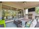 An outdoor kitchen with a stone facade, featuring a built-in grill, sink, and seating area at 30326 Ceasar Park Dr, Wesley Chapel, FL 33543