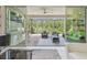Inviting outdoor patio features a kitchen, seating area, and a tranquil view of the backyard at 30326 Ceasar Park Dr, Wesley Chapel, FL 33543