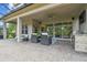 Covered patio with comfortable seating, an outdoor kitchen and a large screened in patio at 30326 Ceasar Park Dr, Wesley Chapel, FL 33543