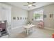 Bright playroom with a window, learning posters, toy kitchen, table with chairs, and vanity table at 30326 Ceasar Park Dr, Wesley Chapel, FL 33543
