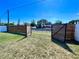 Fenced backyard with an open gate offering access to the waterfront at 3110 10Th N Ave, St Petersburg, FL 33713
