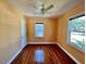 Cozy bedroom featuring hardwood floors, two bright windows, and a ceiling fan at 3110 10Th N Ave, St Petersburg, FL 33713