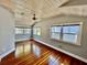 Bright bedroom features hardwood floors, a ceiling fan, and multiple windows for natural light at 3110 10Th N Ave, St Petersburg, FL 33713
