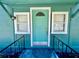 A detailed view of a light-teal door framed by white trim and matching windows for a welcoming entrance at 3110 10Th N Ave, St Petersburg, FL 33713