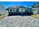 Charming home with a light-teal front door and a newly paved driveway, offering curb appeal at 3110 10Th N Ave, St Petersburg, FL 33713