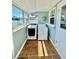 Bright laundry room featuring tile floors, a washing machine, and a dryer at 3110 10Th N Ave, St Petersburg, FL 33713