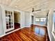 Living room boasts glossy hardwood floors, wooden ceiling, and french doors at 3110 10Th N Ave, St Petersburg, FL 33713