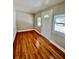 Sunlit living room featuring gleaming hardwood floors and neutral walls creating a warm and inviting atmosphere at 3110 10Th N Ave, St Petersburg, FL 33713