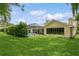 Expansive backyard view, showcasing the lush lawn and screened-in pool area at 3262 Westcott Ct, Palm Harbor, FL 34684